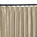 A single beige textured pinch pleat curtain panel hangs from a black rod with matching rings on a white background
