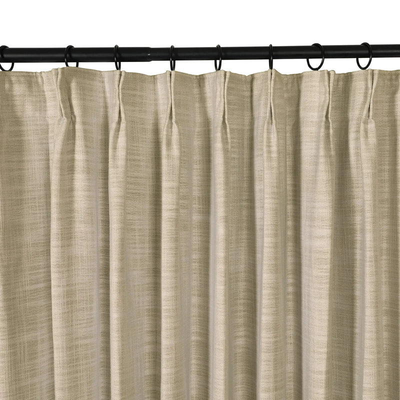 A single beige textured pinch pleat curtain panel hangs from a black rod with matching rings on a white background