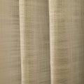 Close-up of neutral beige textured fabric revealing intricate woven details and gentle vertical folds under soft illumination
