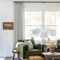 Fog Liz linen curtains shown closer beside a sunlit window with smooth vertical folds