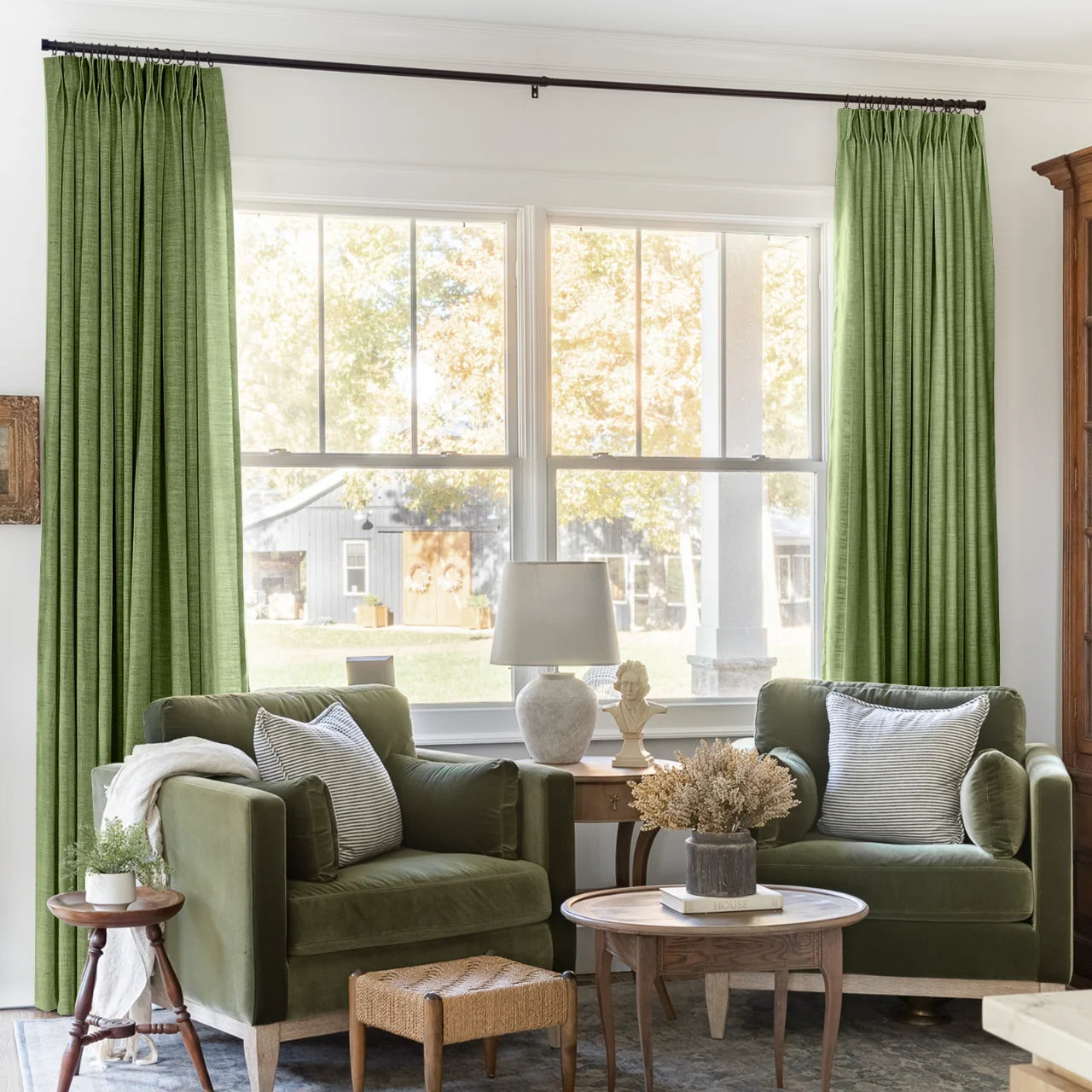 Green Liz linen curtains framing a bright window in a balanced full-length interior view
