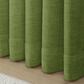 Green Liz linen curtains showing the lower drape and pooling folds near the floor