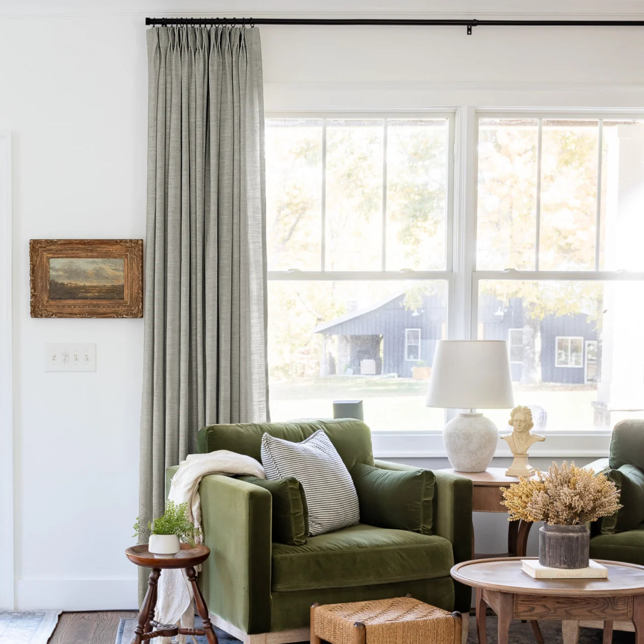 Grey Liz Linen Pleated Curtains beside a green sofa and dried-flower coffee-table arrangement