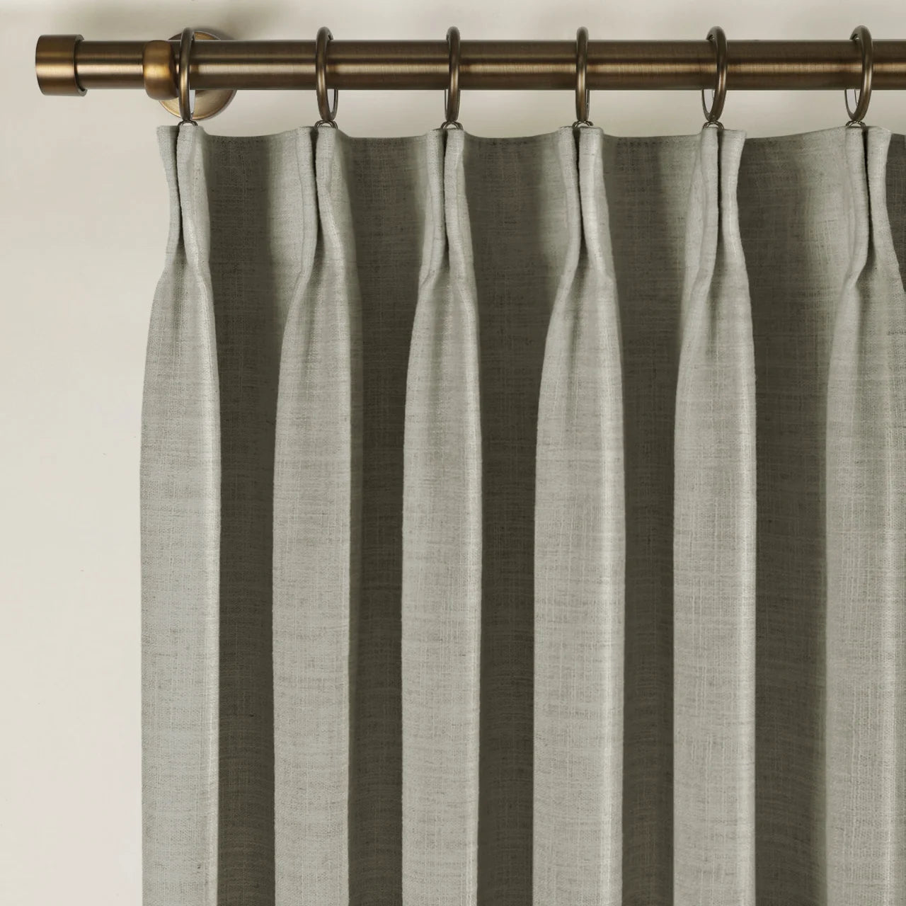 Grey Liz Linen Pleated Curtains triple pinch pleat heading on a bronze curtain rod