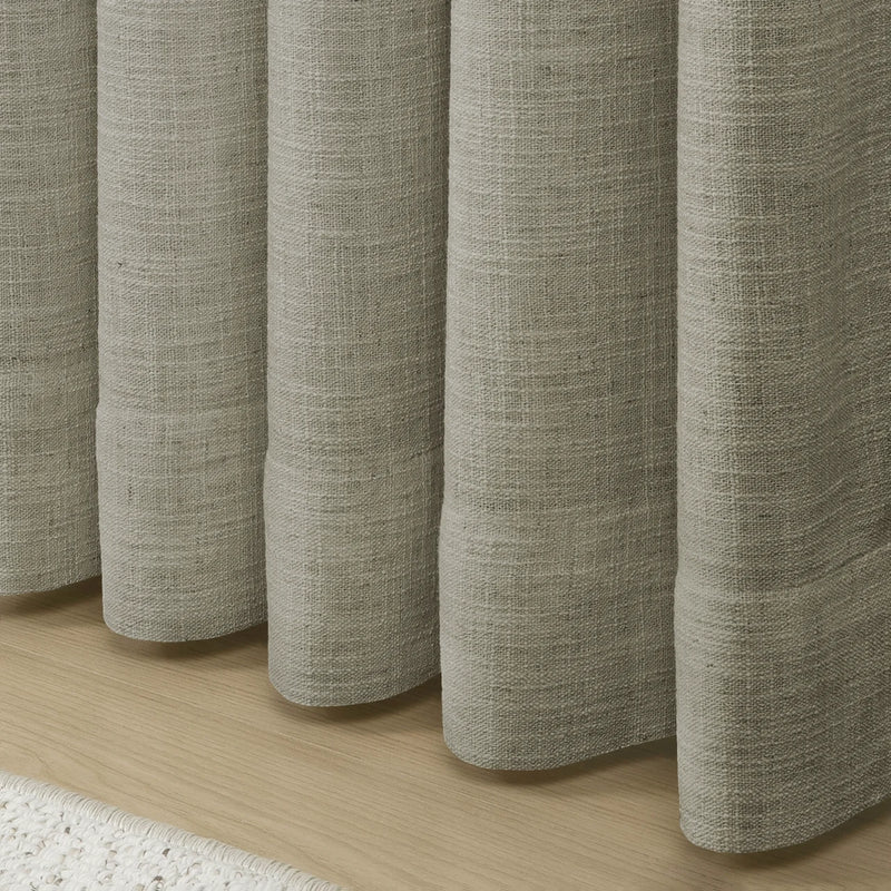 Grey Liz Linen Pleated Curtains rounded curtain hems above a pale wood floor