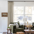 Grey Beige Liz Linen Pleated Curtains beside a green sofa and dried-flower coffee-table arrangement