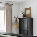 Grey Beige Liz Linen Pleated Curtains in an entryway beside a black cabinet, wall hooks and woven bag
