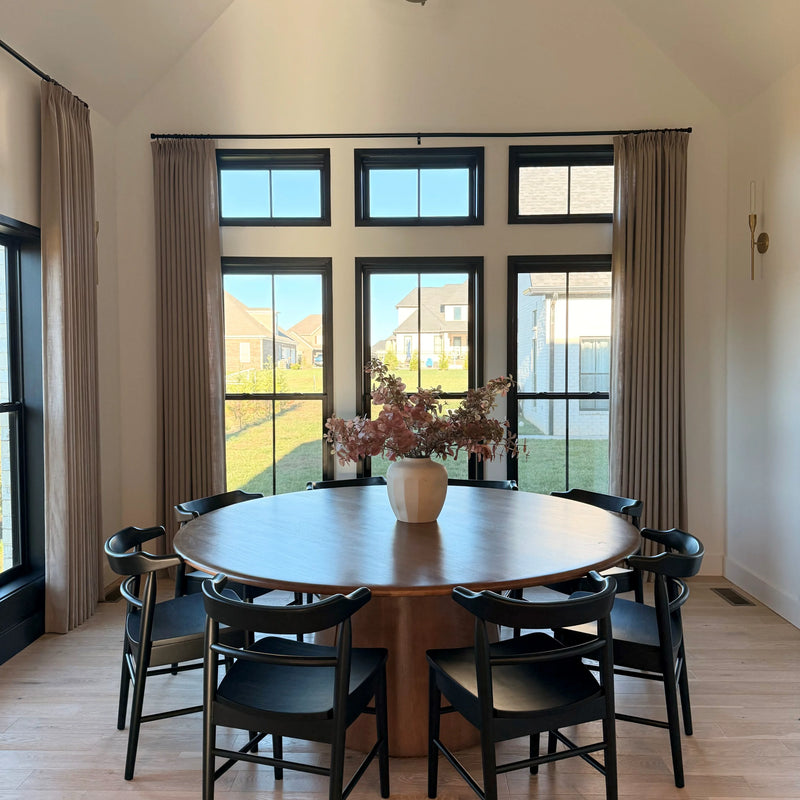Grey Beige Liz Linen Pleated Curtains around transom windows behind a round dark wood dining table