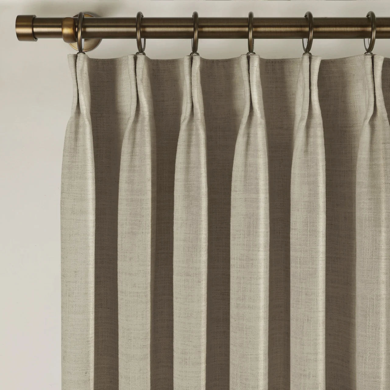 Grey Beige Liz Linen Pleated Curtains triple pinch pleat heading on a bronze curtain rod
