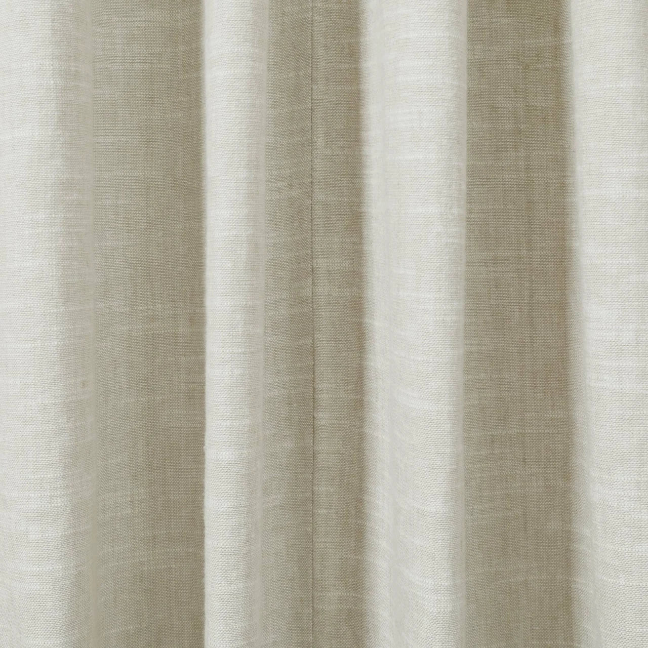 Close-up of a natural beige linen-look fabric curtain with soft vertical folds and a subtle woven texture