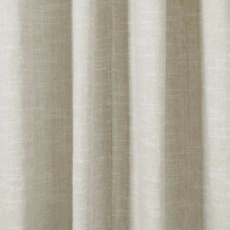 Close-up of a natural beige linen-look fabric curtain with soft vertical folds and a subtle woven texture