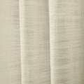 Photograph of a light beige sheer linen-look fabric curtain with prominent vertical folds and a detailed open-weave texture