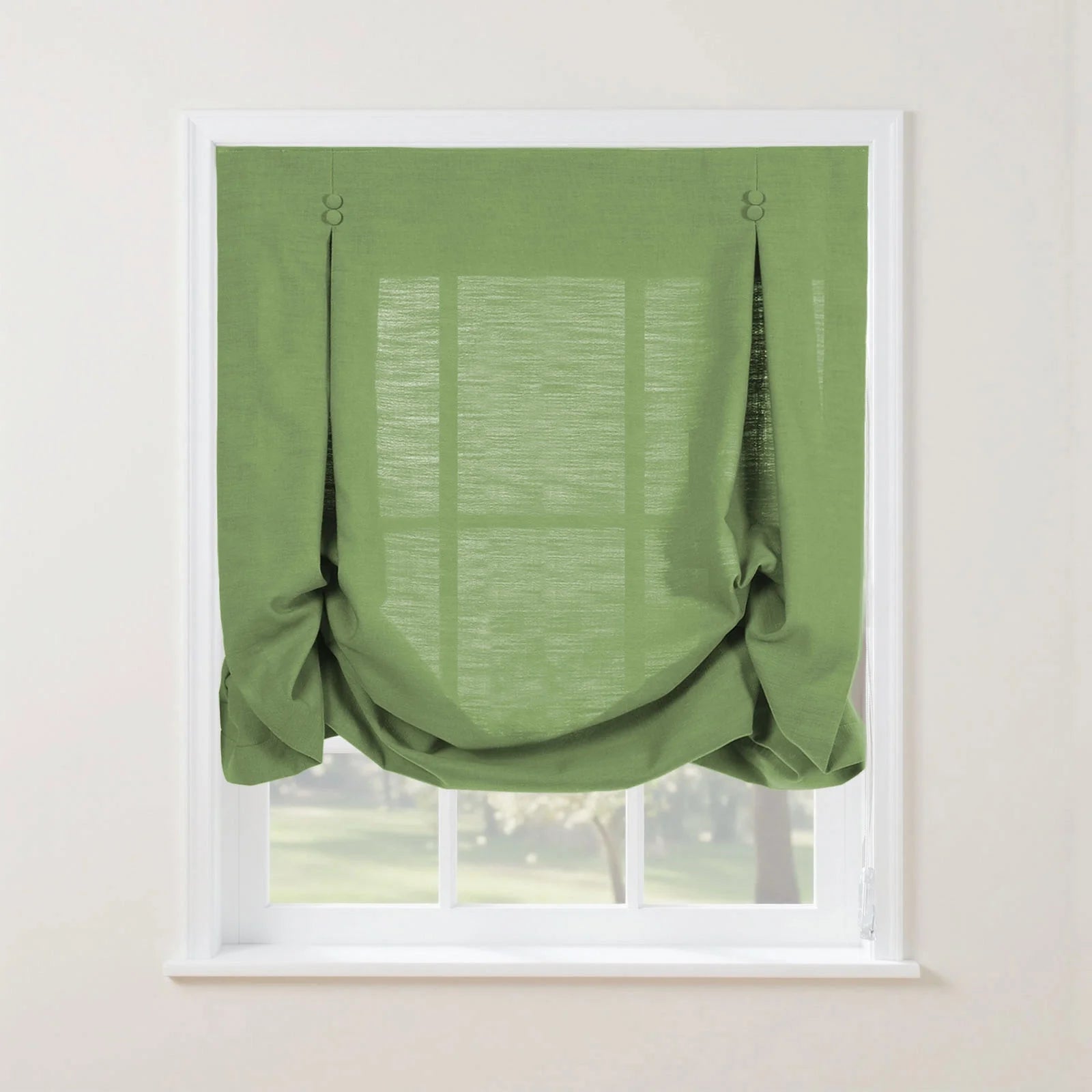 Product photo of a bright green textured faux linen Roman shade featuring top loops with two small round buttons and a softly gathered bottom edge, installed in a white window frame overlooking a vibrant outdoor garden