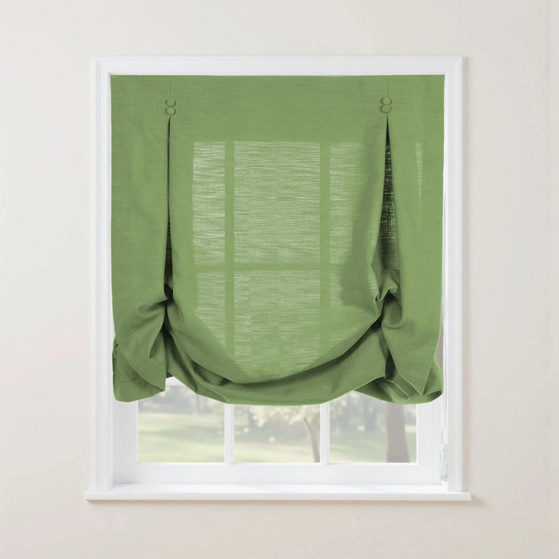 Product photo of a bright green textured faux linen Roman shade featuring top loops with two small round buttons and a softly gathered bottom edge, installed in a white window frame overlooking a vibrant outdoor garden