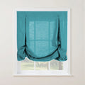 A teal linen-look relaxed Roman shade featuring decorative button-and-loop ties and soft puddled folds at the bottom, installed on a white window frame overlooking a sunlit green garden
