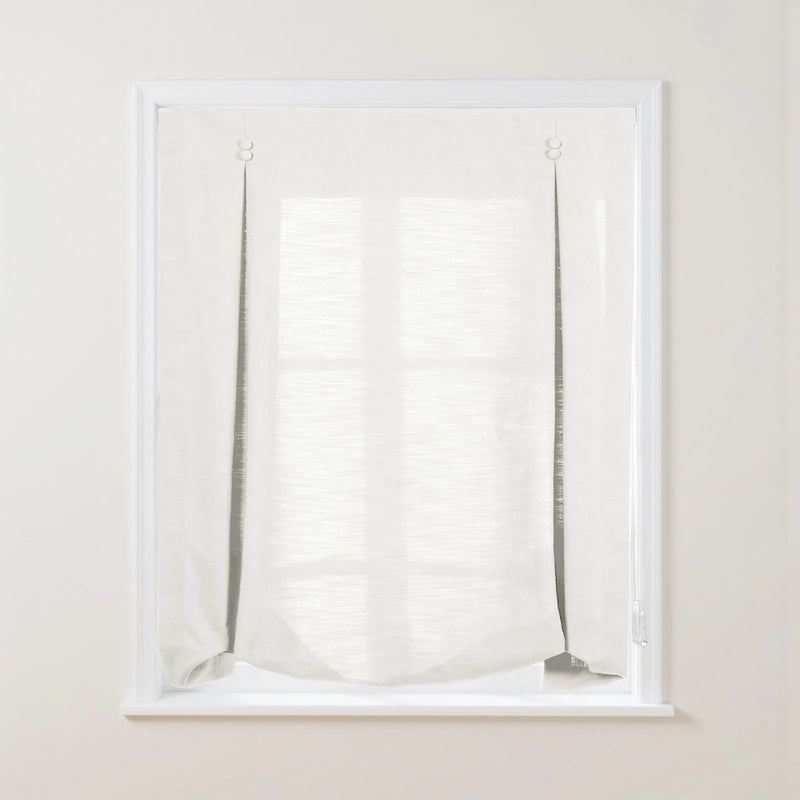 A white textured linen-look Roman window blind with exposed dark cords, light ring fasteners, and a soft bottom drape allowing the window grid to subtly show through