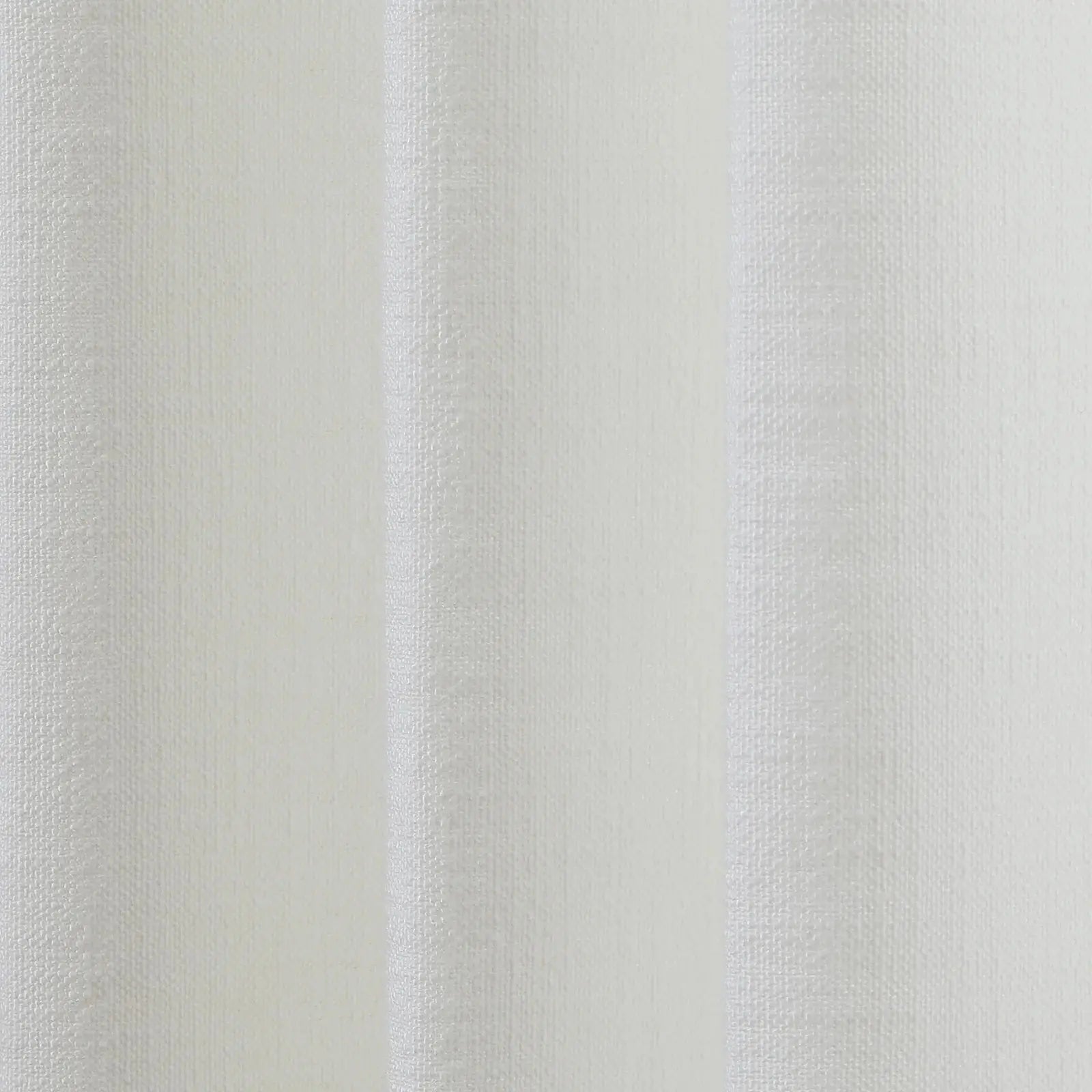 Textured white fabric with subtle vertical ridges creating a soft play of light and shadow