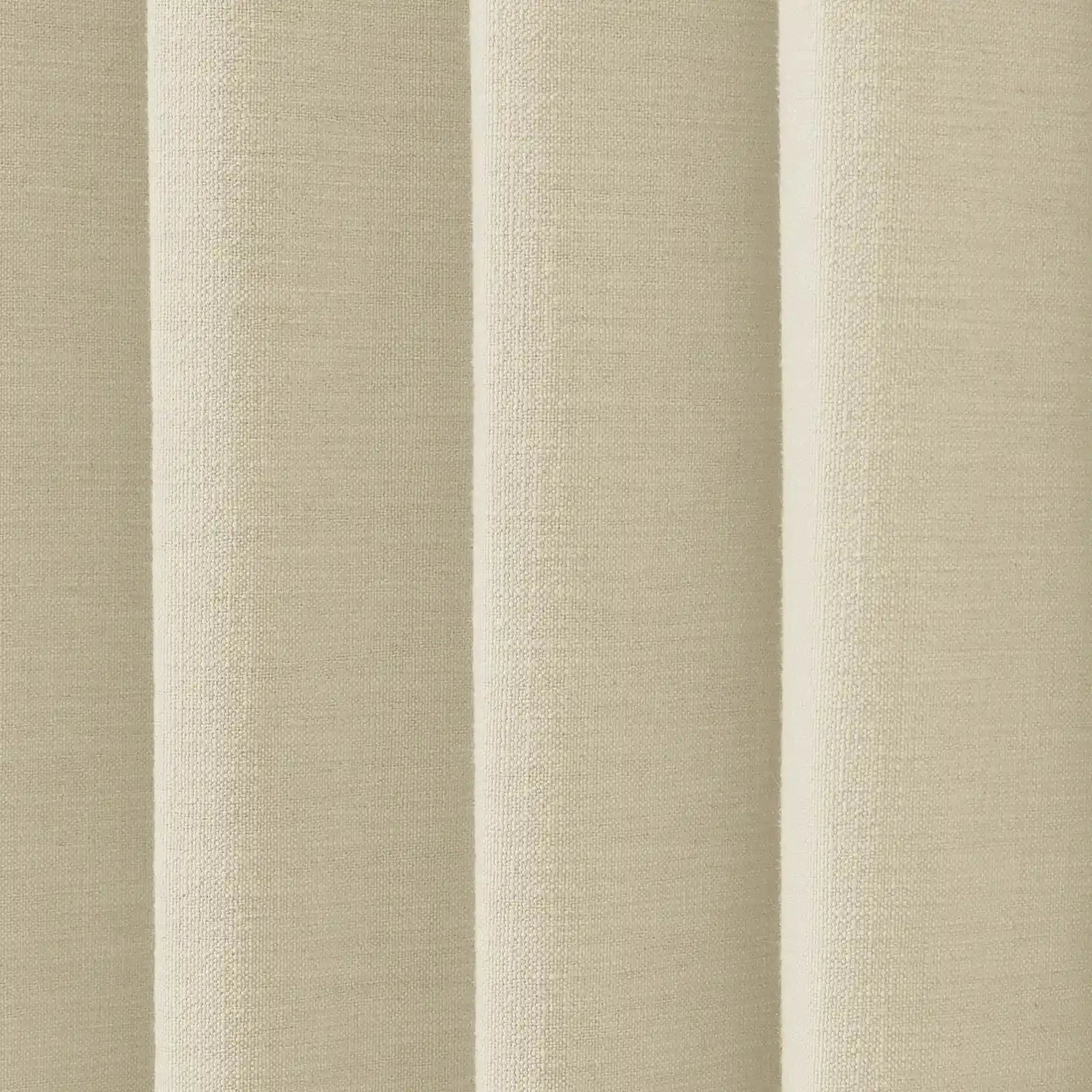 Photograph of a neutral beige woven fabric with prominent vertical folds displaying its textured surface and subtle shading