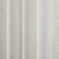Close-up of a white linen-like textured fabric with prominent vertical folds and subtle dark flecks under soft lighting