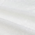 Photograph of white textured fabric with soft creases, a subtle sheen, and a fine weave pattern