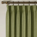 Jade Green Olive Liz linen curtains viewed at an angle in a softly styled room with natural daylight