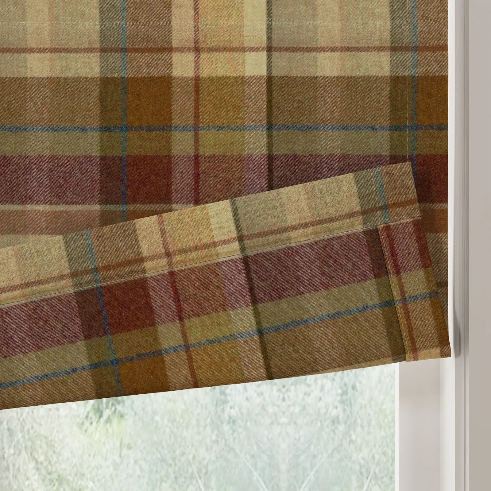 Wool blend Roman blind in a traditional earthy plaid pattern featuring shades of brown, olive, and cream with subtle maroon and blue accent lines, partially lowered at a window revealing a soft fabric fold