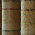 Wool fabric detail of a muted cream and beige tweed with a fuzzy nap, showcasing subtle plaid lines in reddish-brown, olive green, and dull yellow
