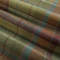 Wool plaid fabric featuring a tartan pattern of olive green, earthy brown, crimson red, teal blue, and subtle pink in soft folds
