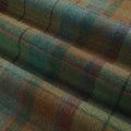Wool plaid fabric draped with soft folds, displaying an earthy pattern of olive green, brown, deep red, and subtle blue lines