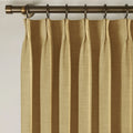 Khaki Liz linen curtains viewed at an angle in a softly styled room with natural daylight