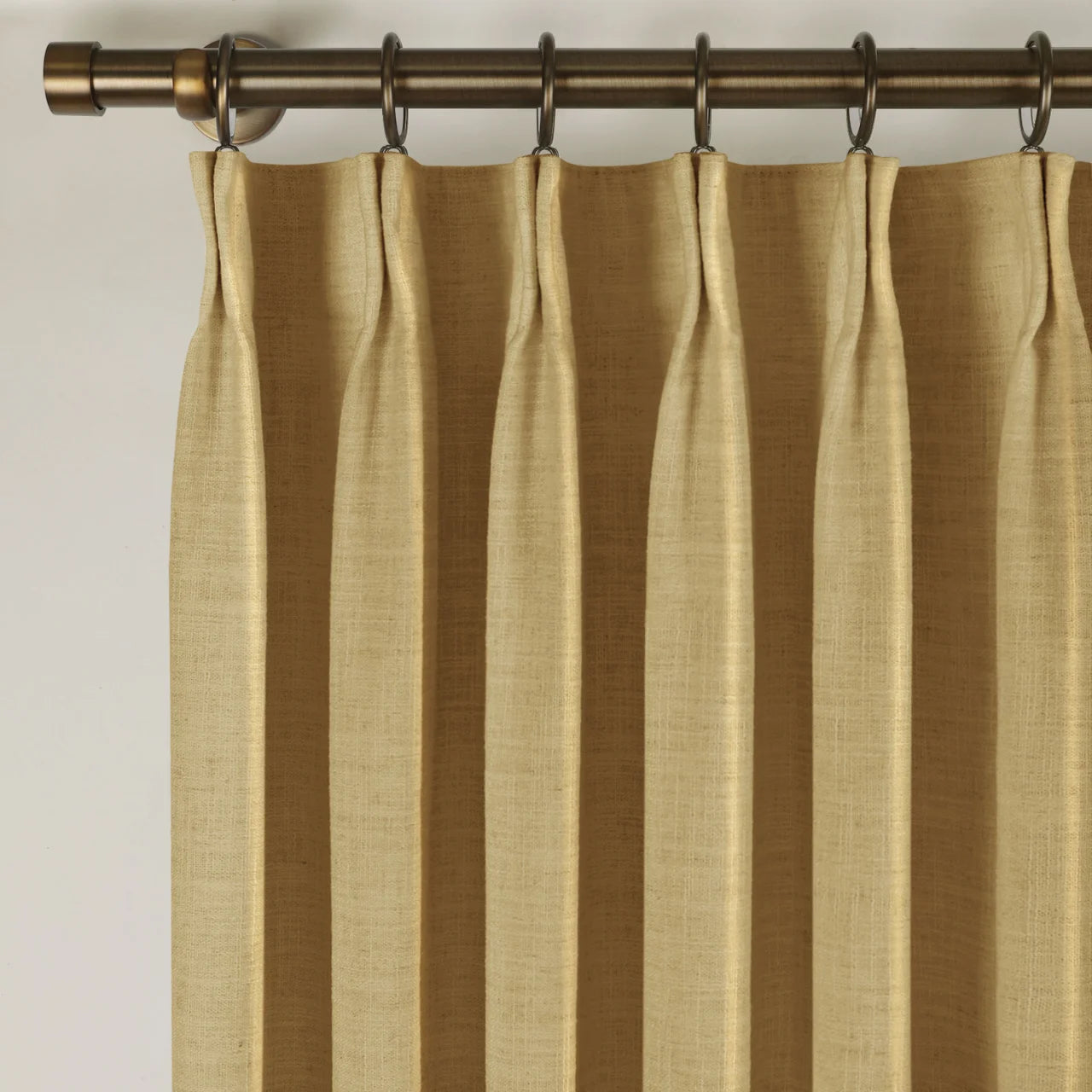 Khaki Liz linen curtains viewed at an angle in a softly styled room with natural daylight