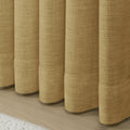 Khaki Liz linen curtains showing the lower drape and pooling folds near the floor