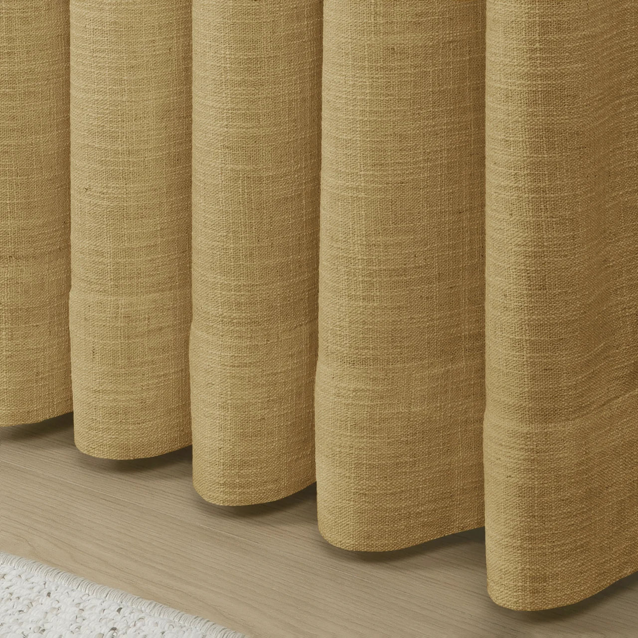Khaki Liz linen curtains showing the lower drape and pooling folds near the floor