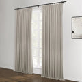 Beige pleated curtains on a black rod flank a large white window in a contemporary room featuring a dark wood floor and a minimalist black and white abstract artwork