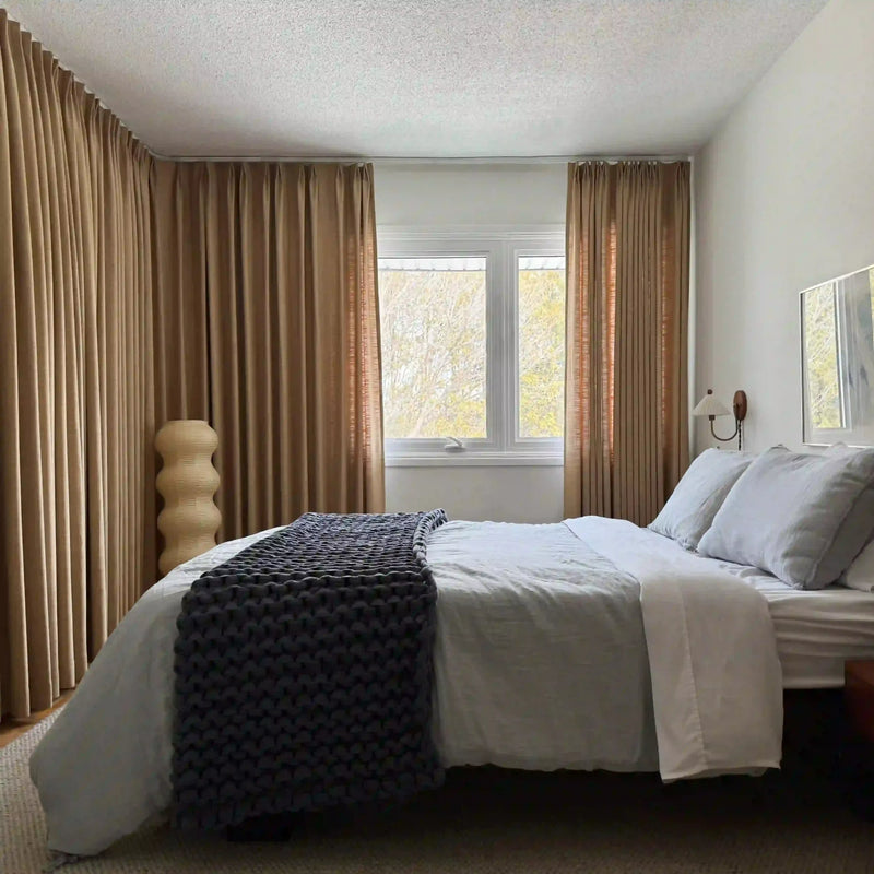 Khaki Yellow Liz linen curtains viewed at an angle in a softly styled room with natural daylight