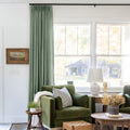 Lagoon Liz linen curtains shown closer beside a sunlit window with smooth vertical folds