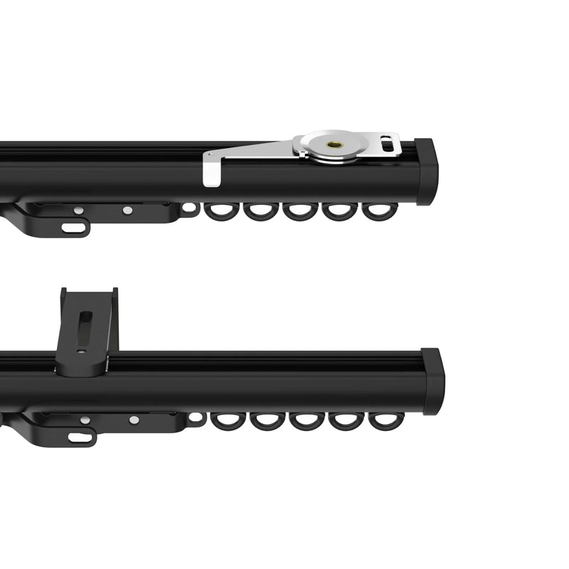 A studio shot of modern black aluminum curtain track components featuring a silver wheeled control mechanism, a black mounting bracket, and C-shaped curtain runners