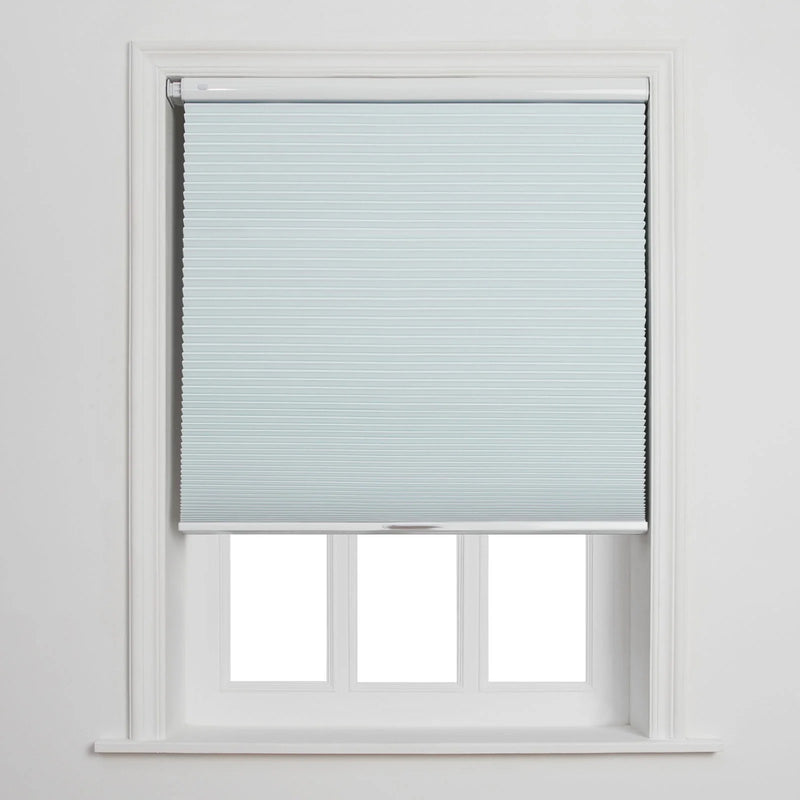 Photograph of a light blue cellular Blind partially covering a white-framed window with three visible lower panes against a plain white wall