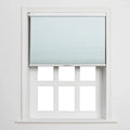 A light blue cellular pleated Blind partially unrolled over a white six-pane window with clean white trim
