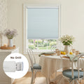 Photograph of a bright dining room with a light blue cellular Blind overlooking a colorful garden, featuring a table set with white daisies and green checkered napkins, with a 'No Drill' ppoleuct feature highlighted