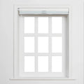 A white framed window with nine individual panes and a partially lowered white roller Blind featuring two light blue horizontal stripes and silver pulls against a plain white interior wall