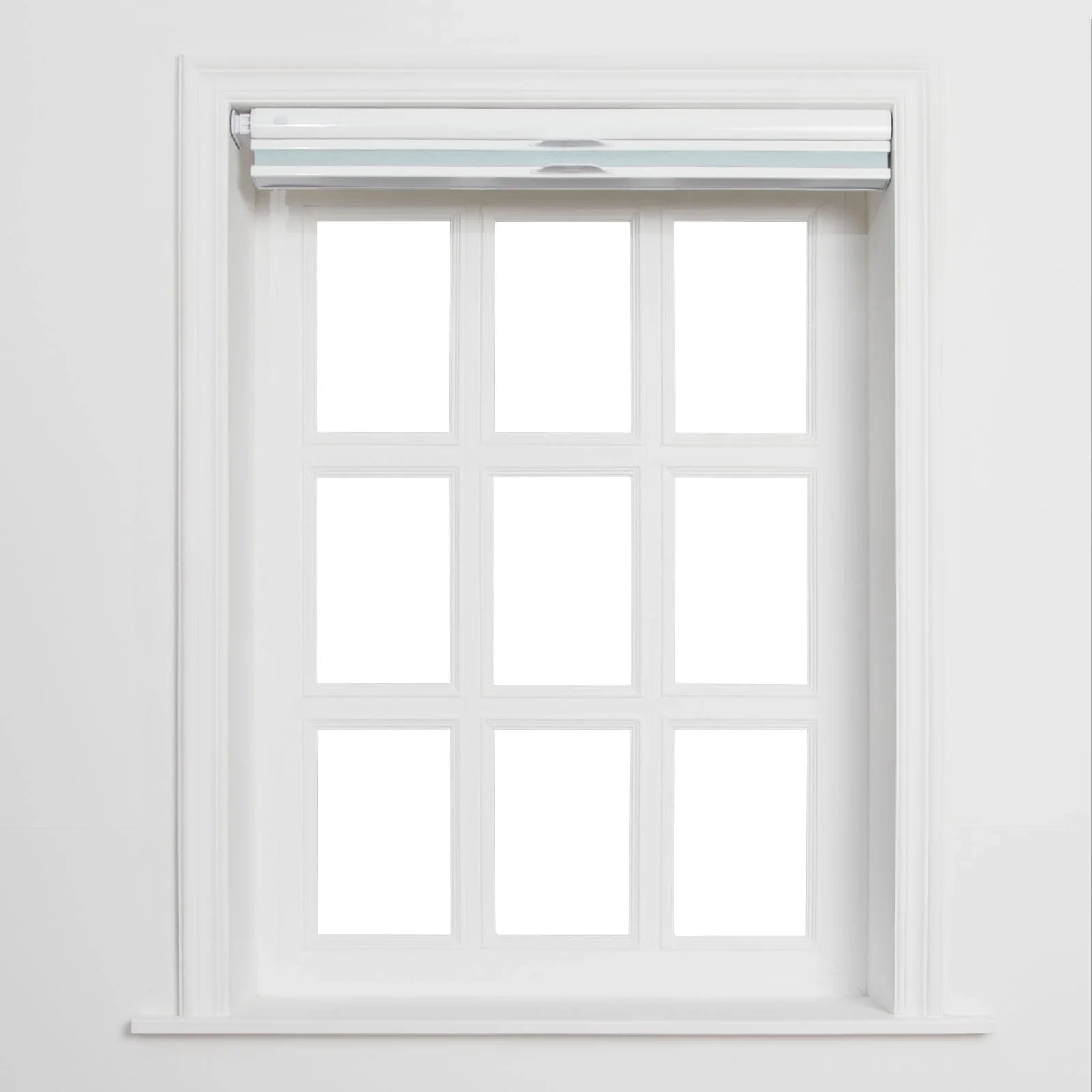 A white framed window with nine individual panes and a partially lowered white roller Blind featuring two light blue horizontal stripes and silver pulls against a plain white interior wall