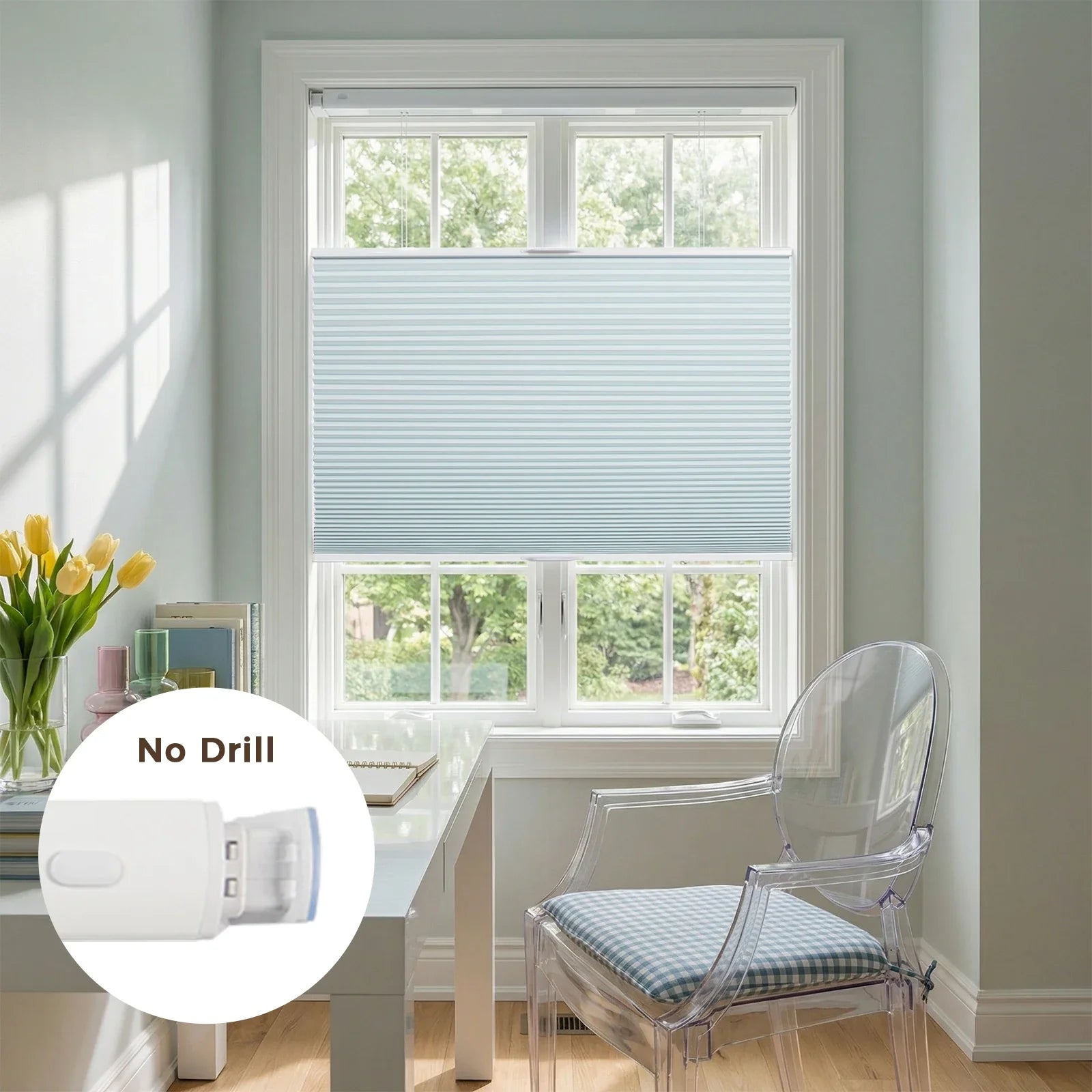 Photography of a modern home office featuring a bright window with light blue cellular Blinds, a white desk holding yellow tulips in a vase, and a transparent ghost chair with a blue gingham cushion, showcasing a "No Drill" installation detail