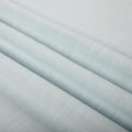 Pale aqua fabric with gentle diagonal folds showcasing a subtle woven texture