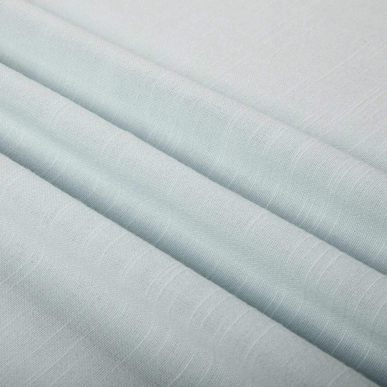 Pale aqua fabric with gentle diagonal folds showcasing a subtle woven texture