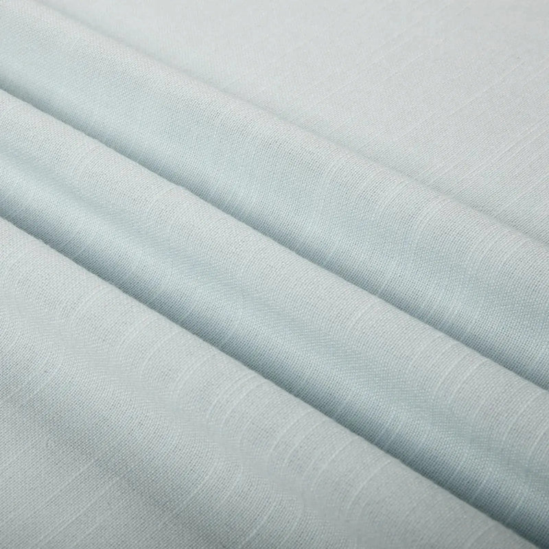 Pale aqua fabric with gentle diagonal folds showcasing a subtle woven texture