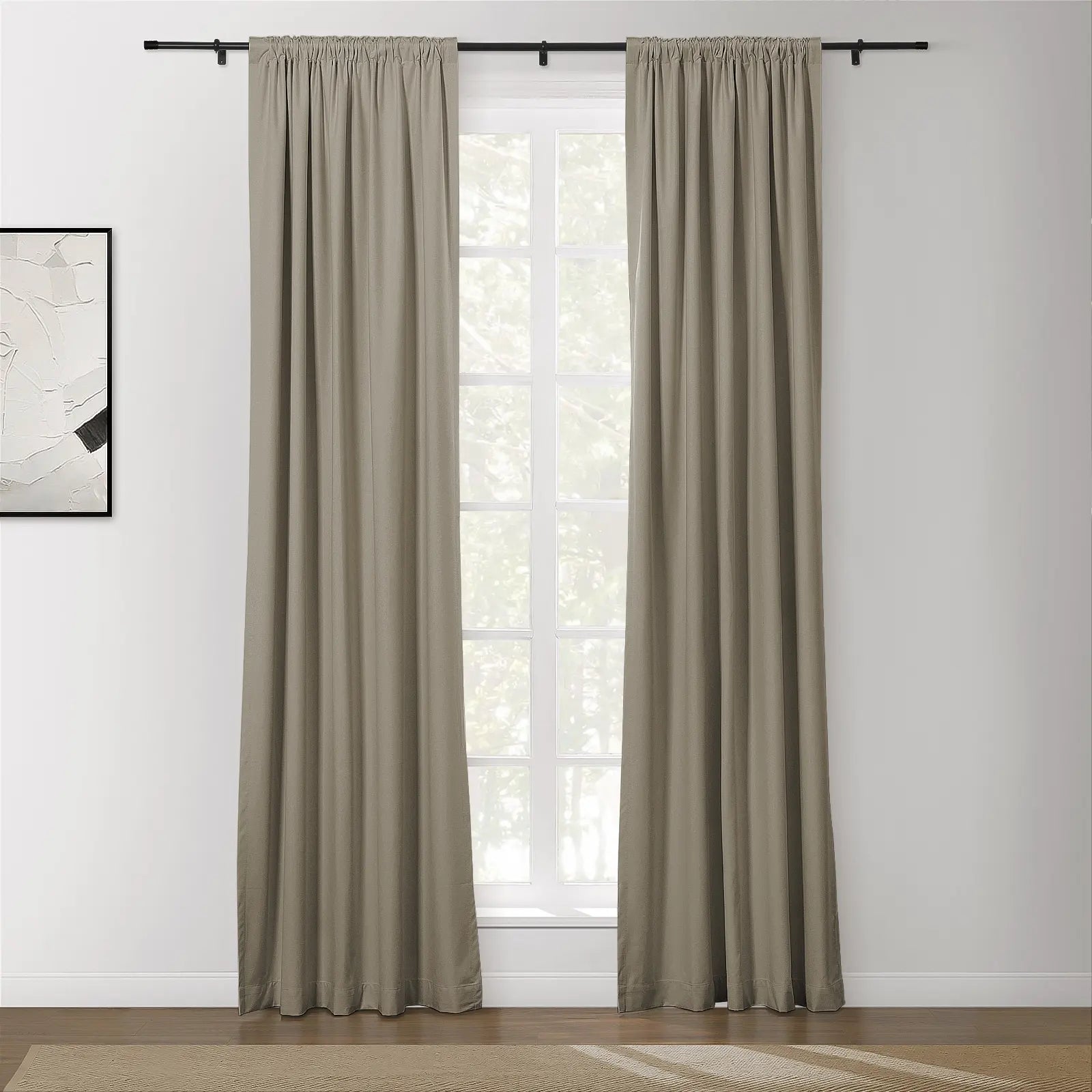 Beige rod pocket curtains frame a white grid window in a minimalist room with abstract wall art and a textured herringbone rug