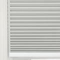Close-up of a light grey pleated Blind featuring distinct horizontal folds and a subtle textured fabric set within a bright white window frame