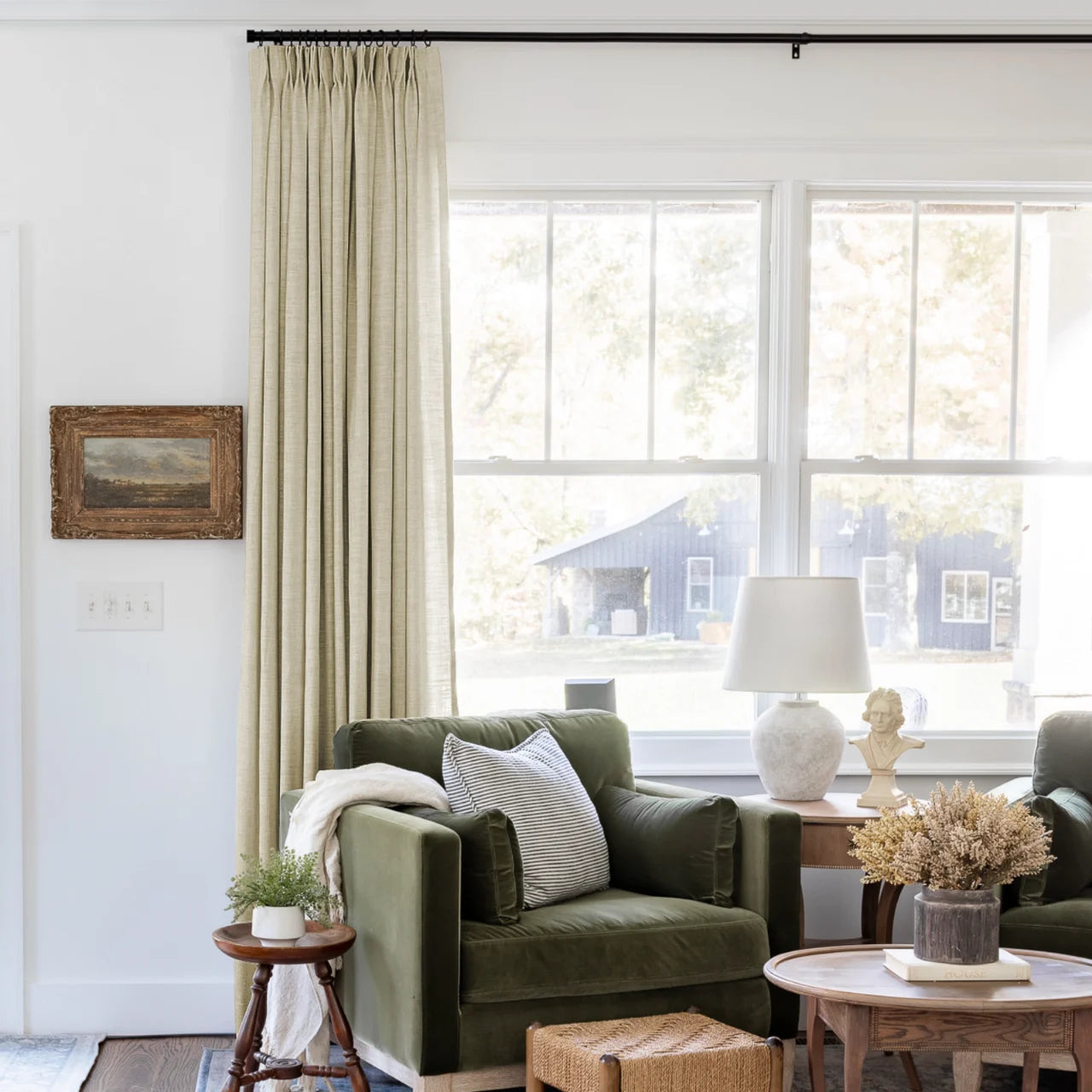 Light Khaki Liz Linen Pleated Curtains beside a green sofa and dried-flower coffee-table arrangement