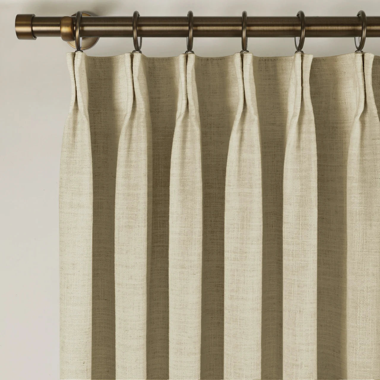 Light Khaki Liz Linen Pleated Curtains triple pinch pleat heading on a bronze curtain rod
